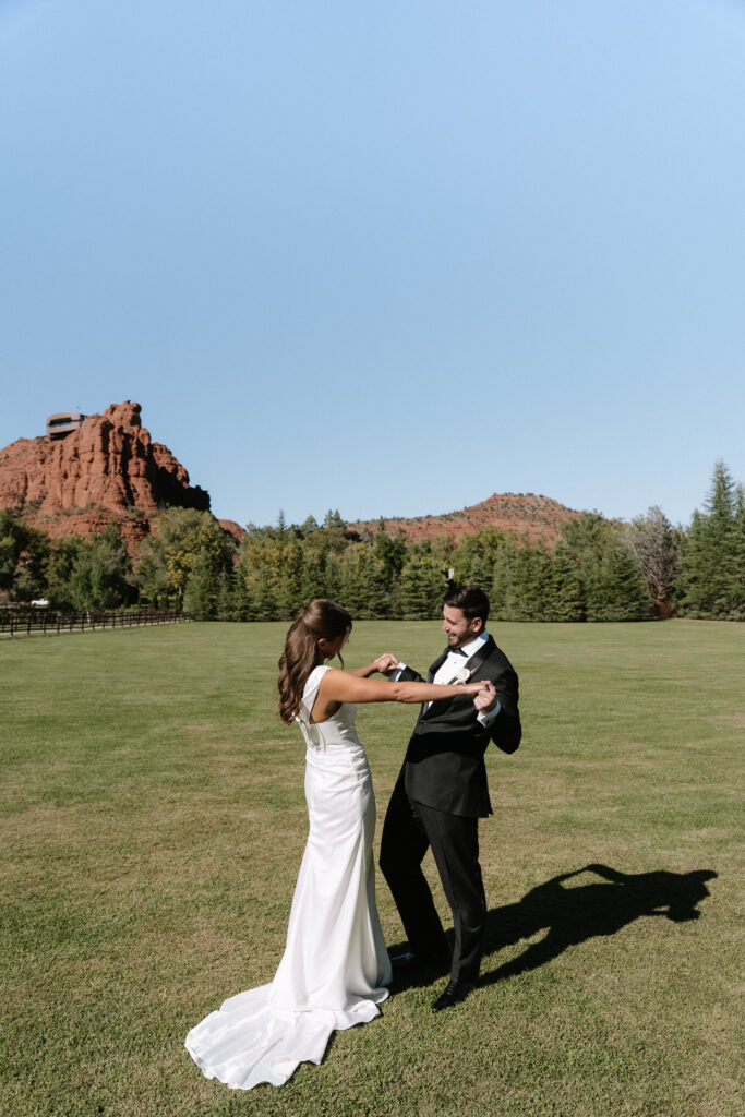 Husband and wife enjoy a first look in front of red rock in Sedona, Arizona