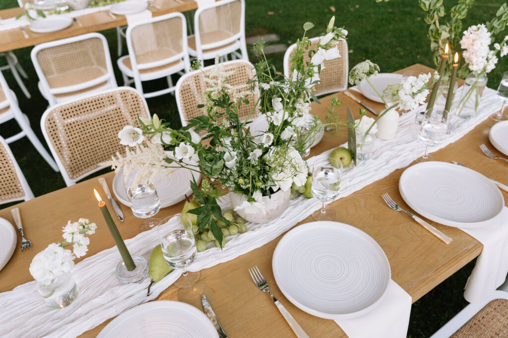 White and Green Floral Arrangement on wedding reception table